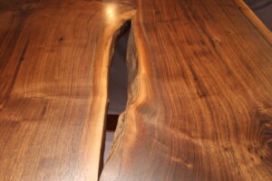 close up view of live edge table polished and stained with excellent view of woodgrain texture