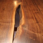 close up view of live edge table polished and stained with excellent view of woodgrain texture