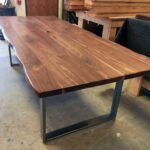 Smooth polished table top with dark stain - live edge houston texas design examples with metal base